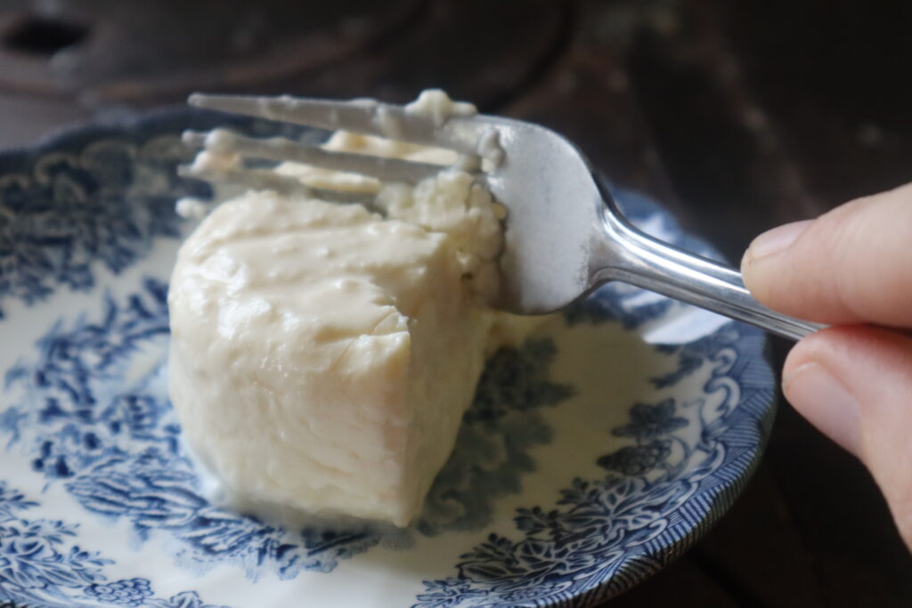 feta cheese on a plate with a fork cutting into it