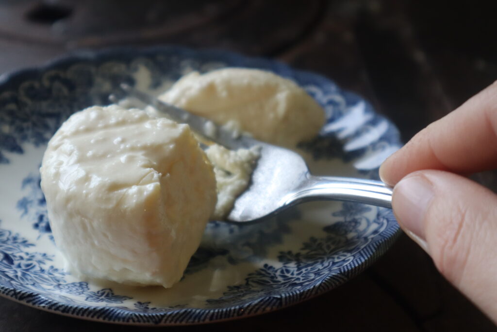 fork cutting a feta cheese 
